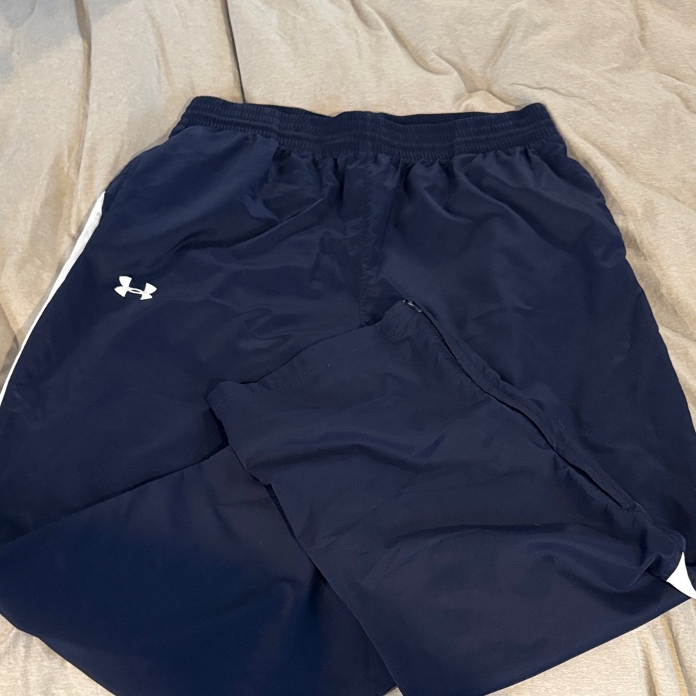 Blue and white Under Armour 3XL wind pants.  Black with white stripes down leg